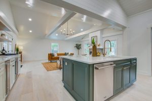 A modern kitchen with light walls and green cabinets stays in pristine condition with on-time repairs.